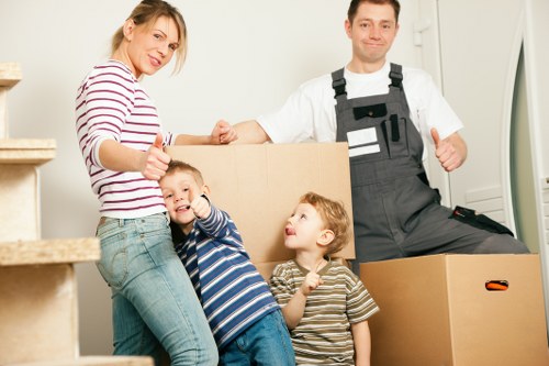 Removal company crew loading boxes and furniture for a local house move